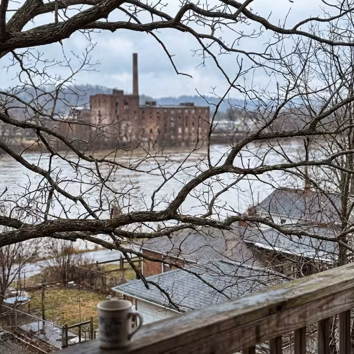 View of Ohio River through bare winter trees from a cottage porch